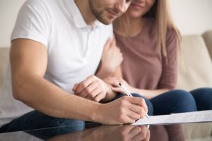 Couple signing financial agreement